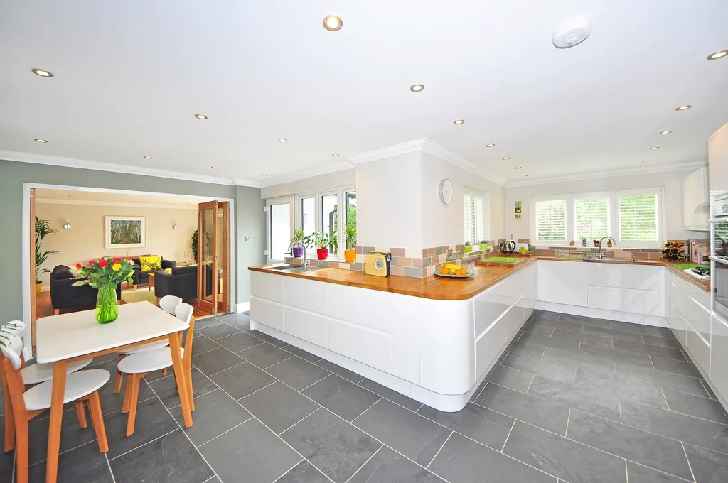 Bright remodeled kitchen with white cabinets and a tiled floor